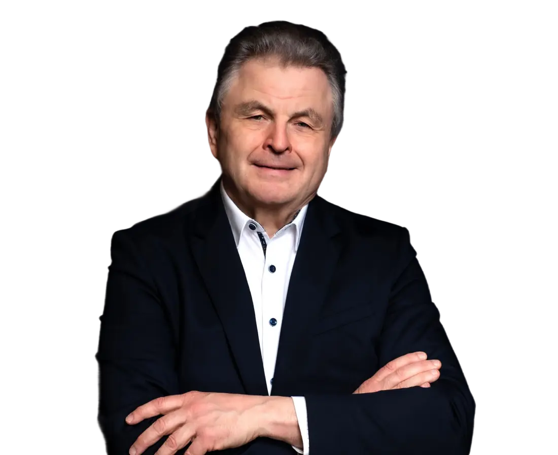 Man in a black suit smiling