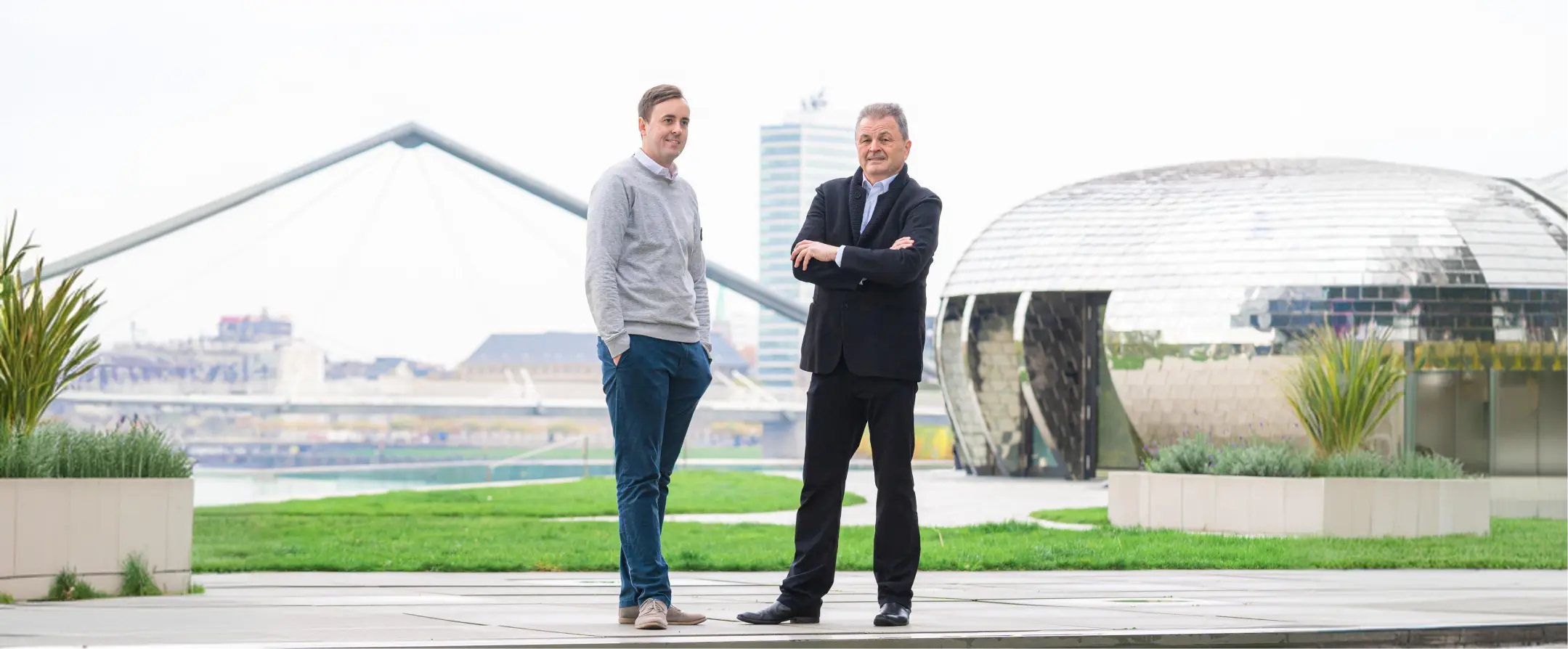 Two men standing in a modern outdoor setting