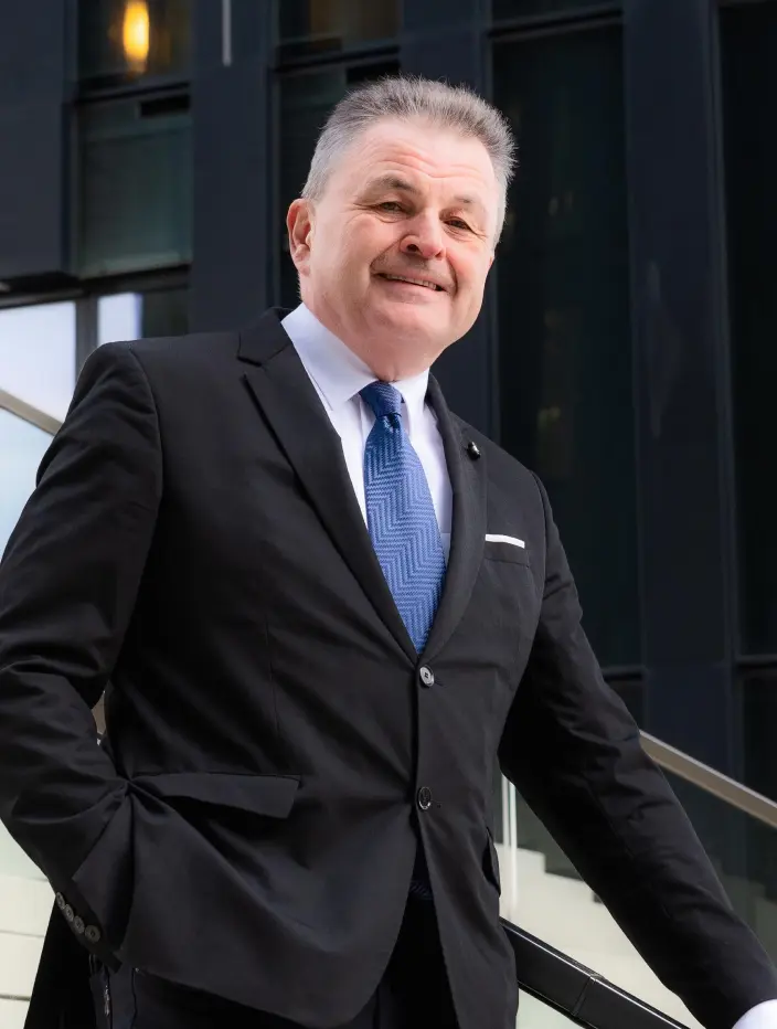 Man in a suit walking upstairs